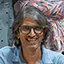 a photo of a happy male dance student with glasses and long grey hair