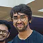 a photo of a smiling male dance student with glasses and a slight beard